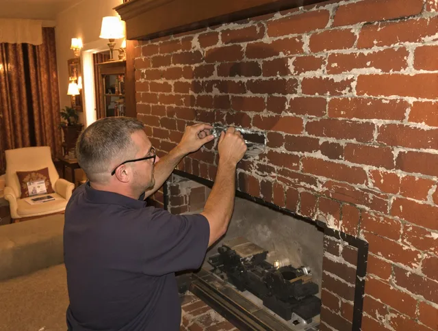 Ellington Chimney Sweep expert fixing a fireplace in Ellington, CT